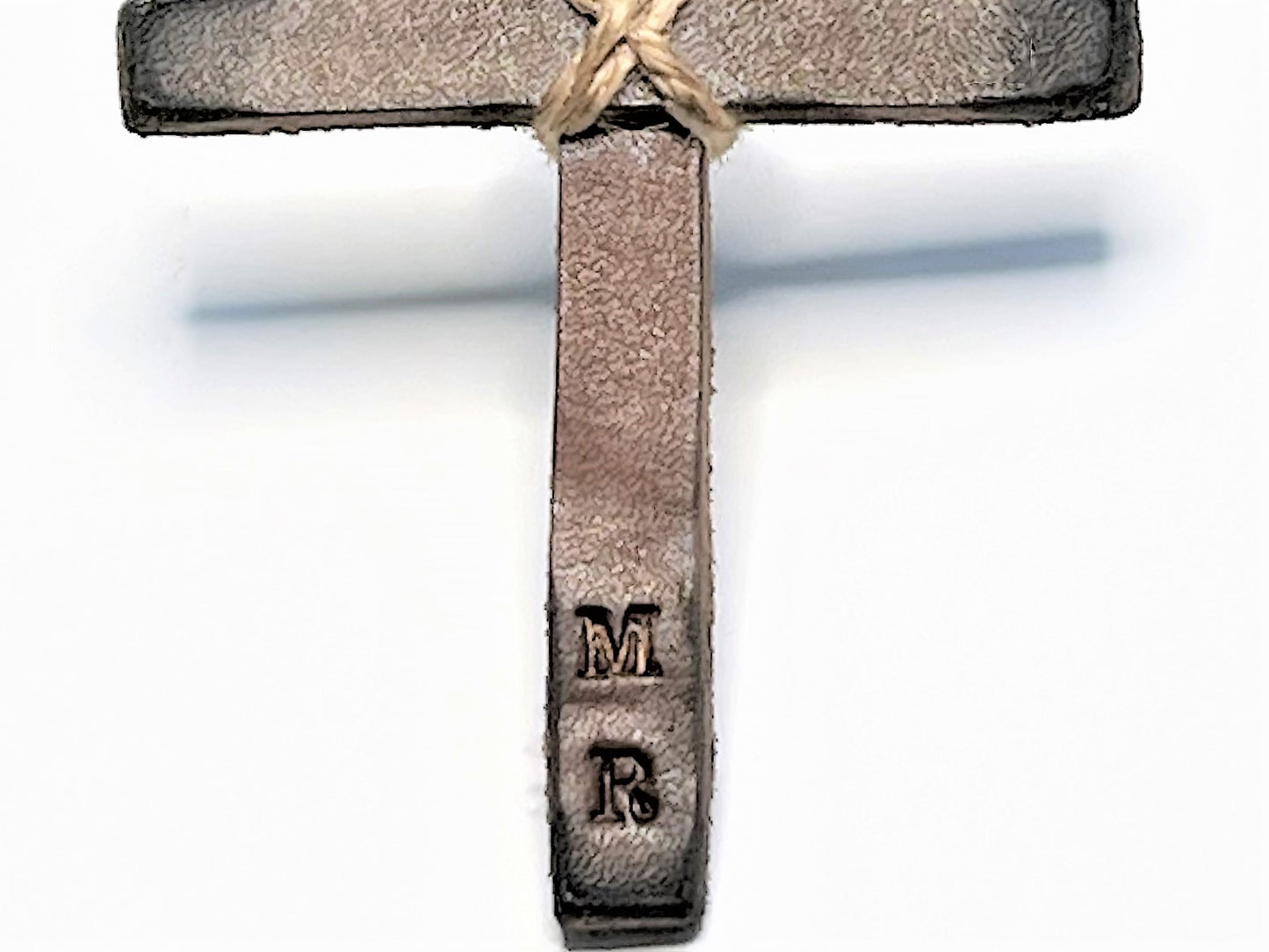 Close up Decorative Car Hanging Leather Cross ornament, with custom stamped 'MR' initials