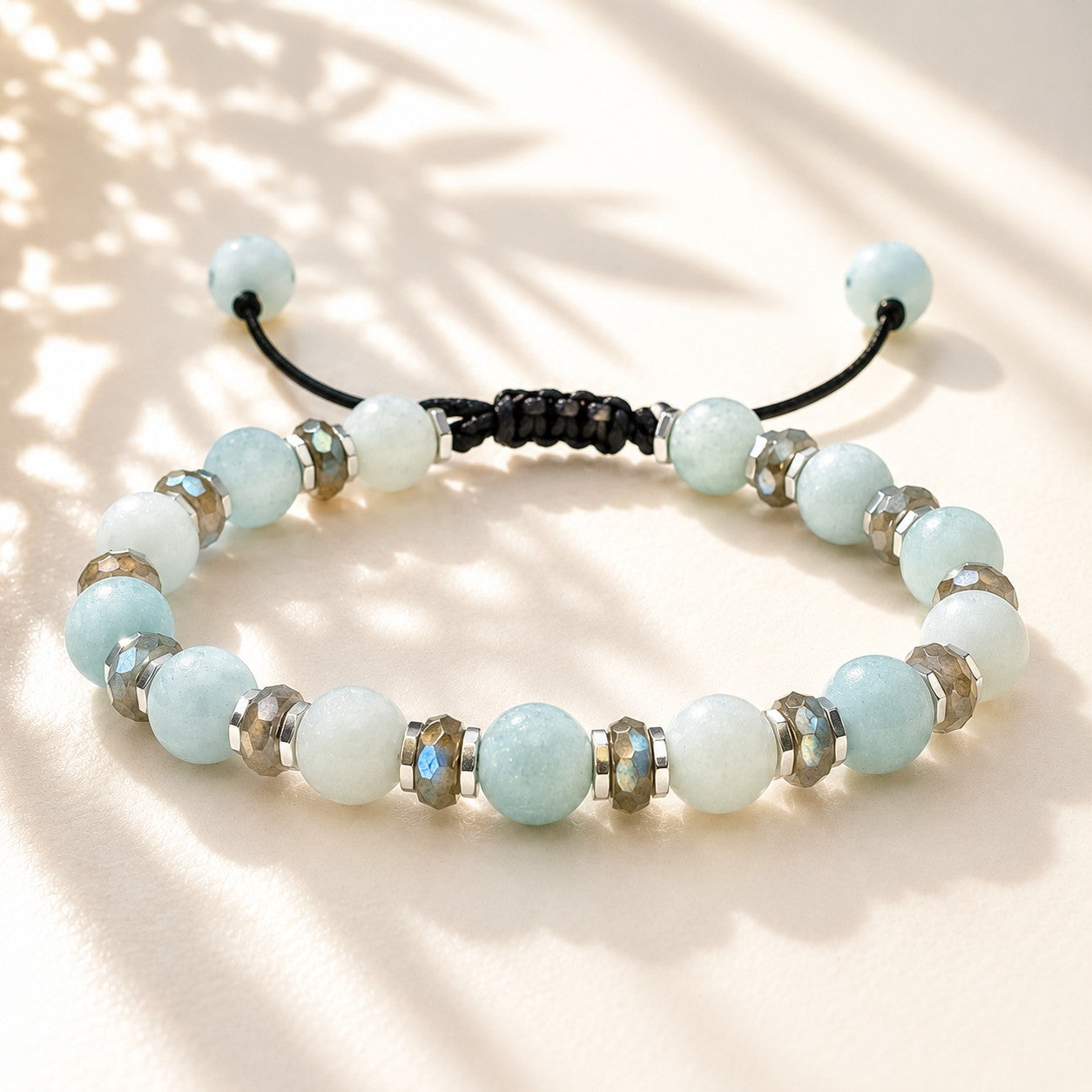 Handmade adjustable Amazonite, Labradorite, and Hematite gemstone bracelet for women featuring natural light blue Amazonite beads, shimmering faceted Labradorite spacers with iridescent flash, and polished Hematite accents. Waterproof adjustable cord bracelet for everyday wear, yoga, meditation, healing crystal jewelry, birthday gift, anniversary gift, Mother's Day gift, and boho minimalist fashion accessory.