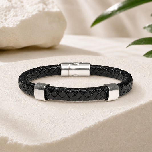 Black braided leather bracelet with a polished silver magnetic clasp and two silver engravable slider charms. Minimalist unisex bracelet handcrafted from genuine braided leather, featuring a sleek modern design suitable for everyday wear, gifts, anniversaries, and personalized engraving.