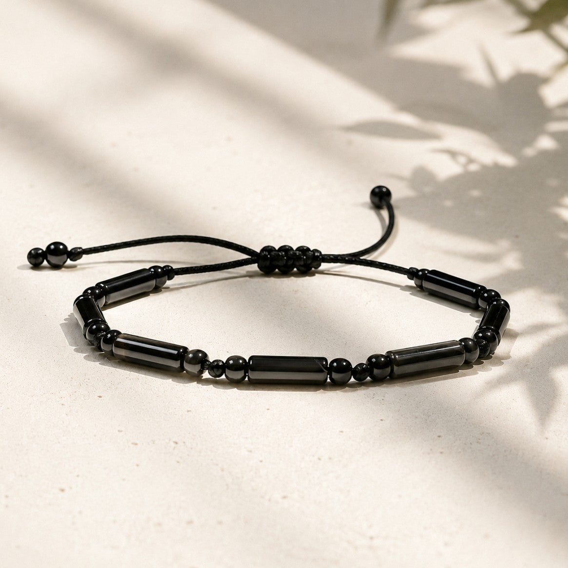 Adjustable black onyx bracelet with tube and round gemstone beads on waterproof black cord, minimalist protection jewelry