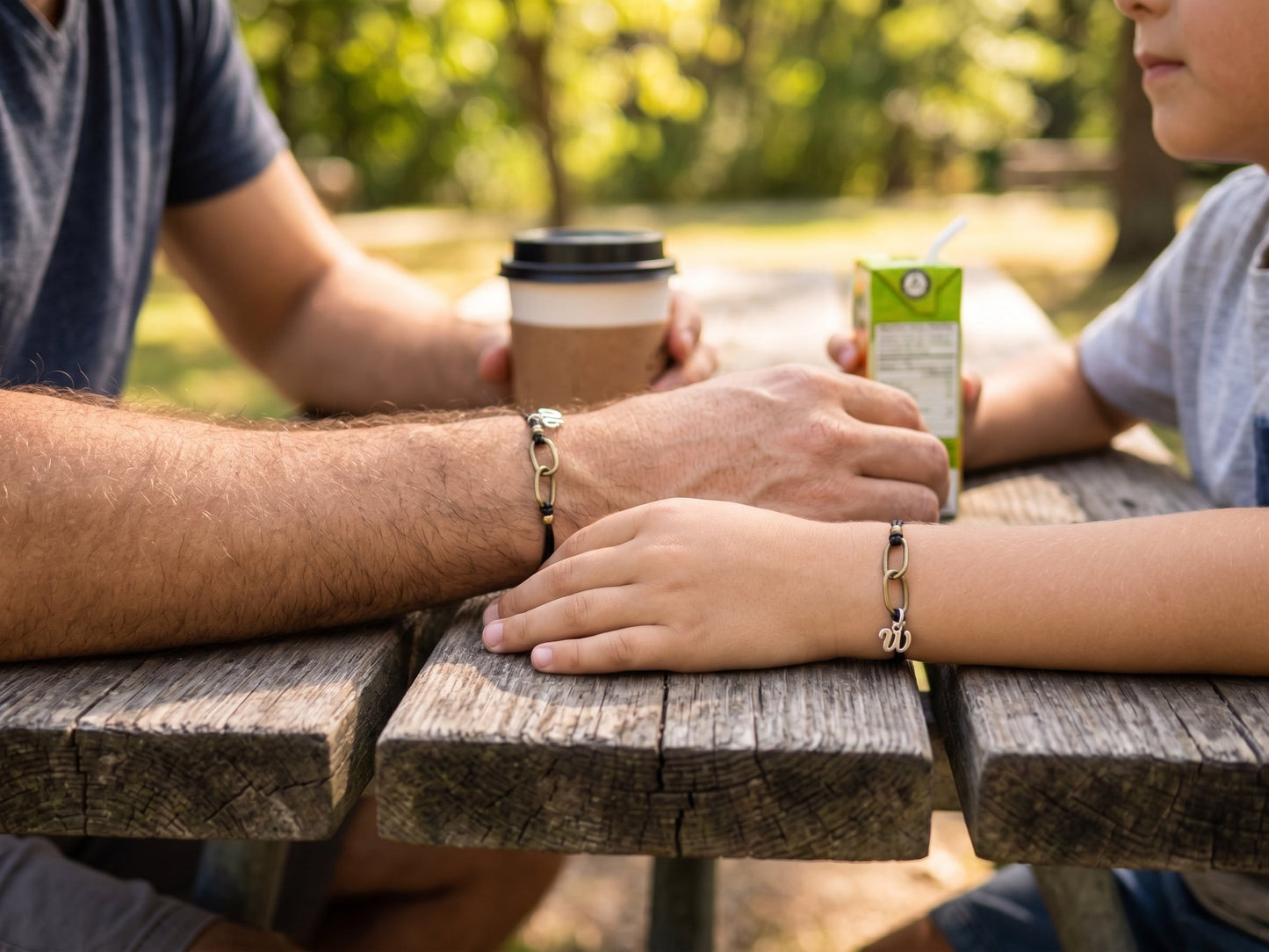 Matching father and son jewelry handcrafted with durable black nylon cord and antique brass accents, symbolizing lifelong connection and love.