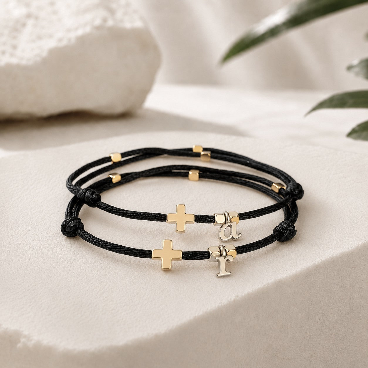 Personalized matching black cord bracelet set with gold cross charms, gold accent beads, and custom initial letter charms, adjustable minimalist Christian friendship bracelets for couples, family, or loved ones.