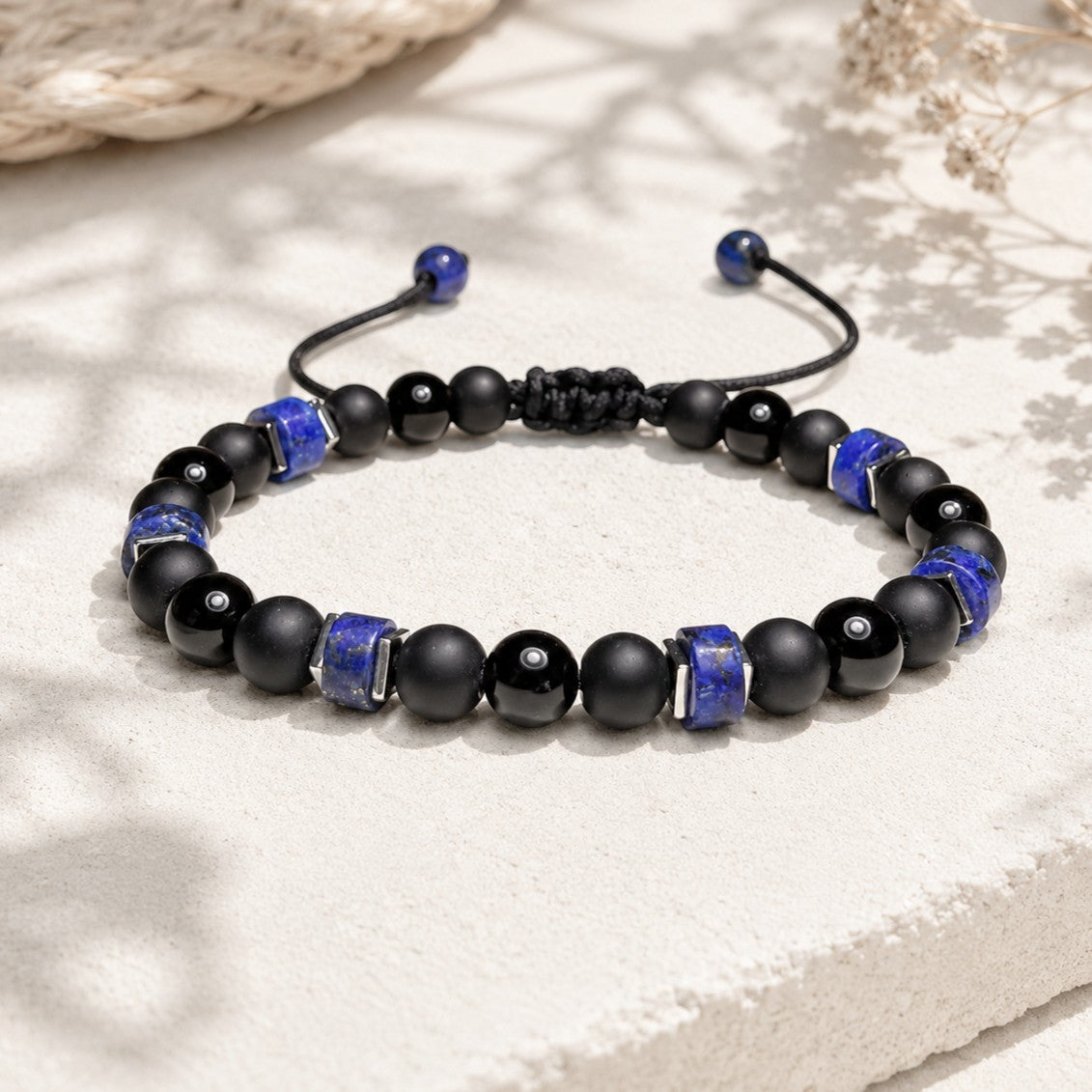 The Black Onyx with Lapis lazuli bracelet is easily adjustable and waterproof. It is excellent for both men and women. The bracelet features 6mm round Black Onyx gemstones embellished with Heishi Lapis Lazuli beads and square silver Hematite beads.
