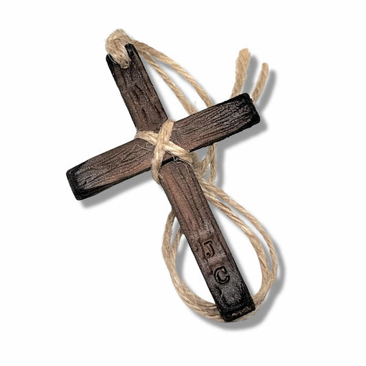 Handcrafted brown leather cross with twine wrapping and hanging loop, designed as a Christian car ornament for the rear-view mirror.
