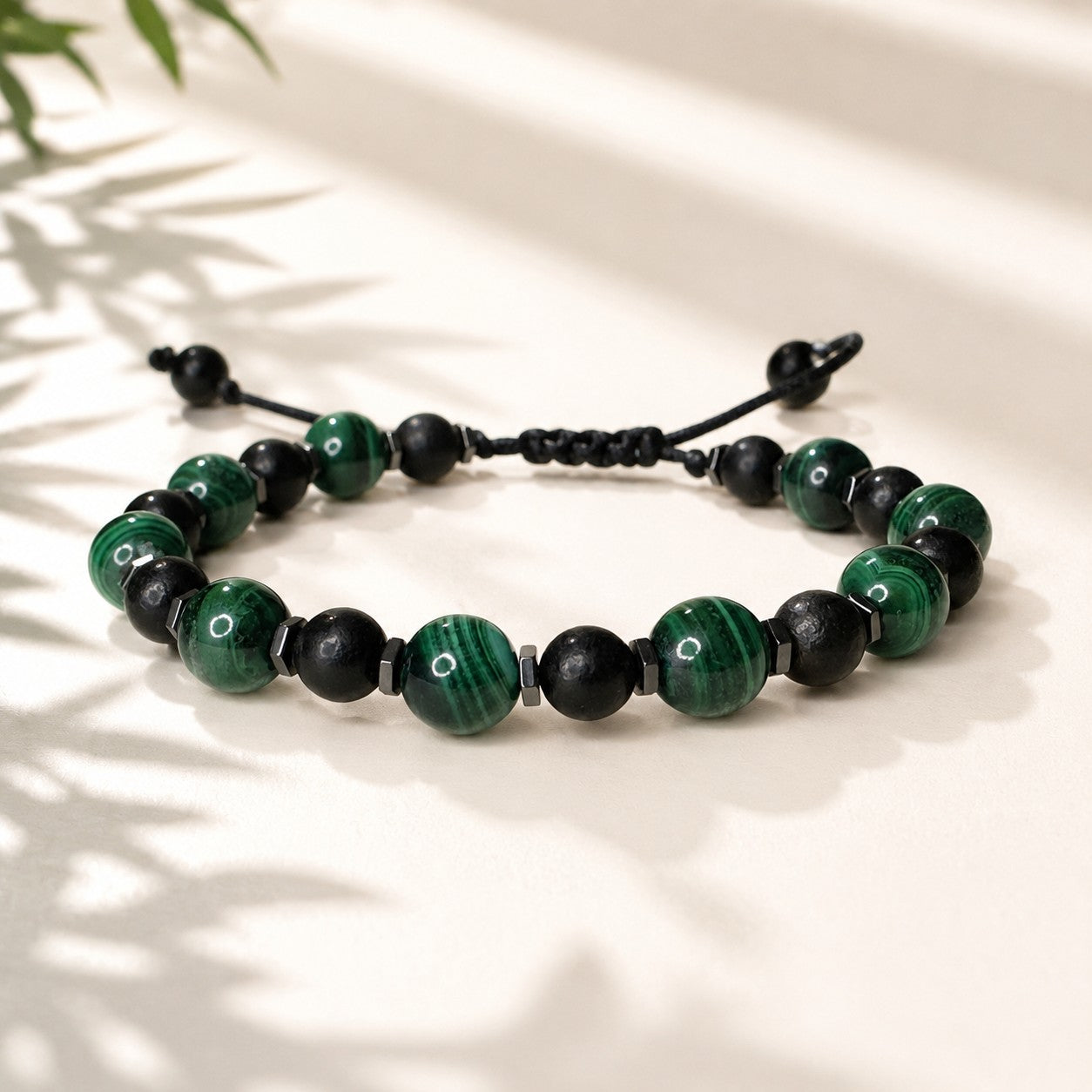 Handmade adjustable Malachite, Black Tourmaline, and Hematite gemstone bracelet for women and men featuring natural banded green Malachite beads, protective Black Tourmaline gemstones, and polished Hematite spacer beads. Waterproof personalized crystal bracelet with durable adjustable cord for everyday wear, meditation, yoga, boho style, couples, birthdays, anniversaries, Father's Day, Mother's Day, and meaningful healing gemstone gifts.