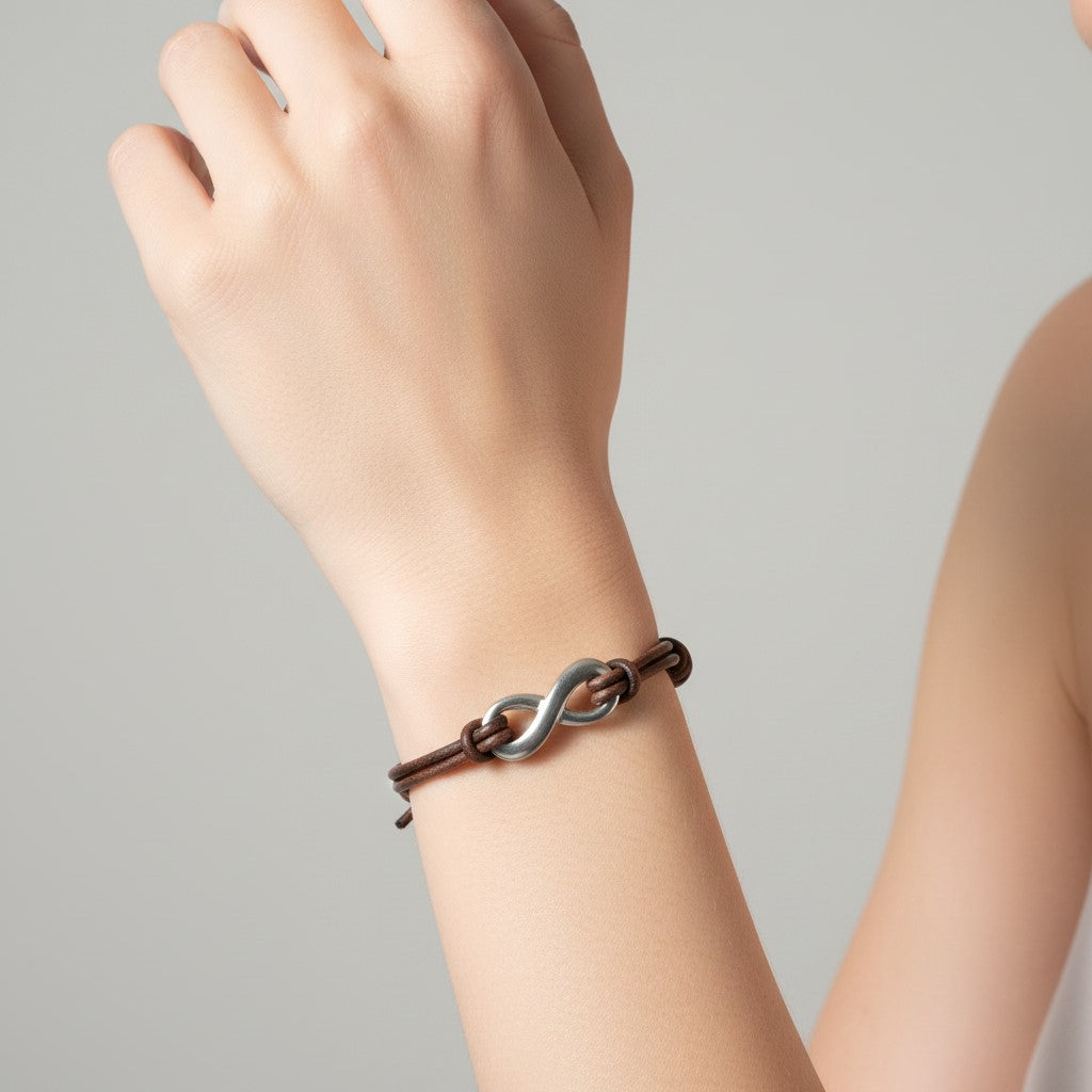 A woman wearing an infinity  and distressed leather bracelet 