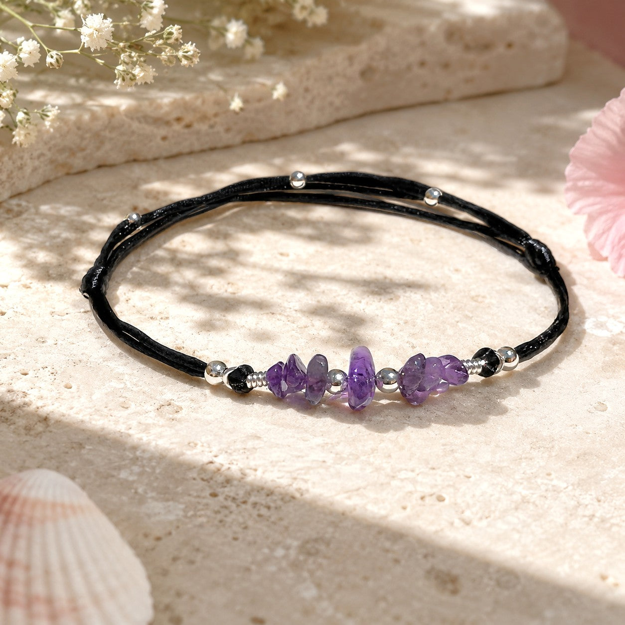 Dainty amethyst anklet with smooth purple gemstones on a black adjustable nylon cord, accented with silver-plated beads and an optional initial charm. A waterproof, personalized gift for women or teens, ideal for birthdays, holidays, or spiritual healing.