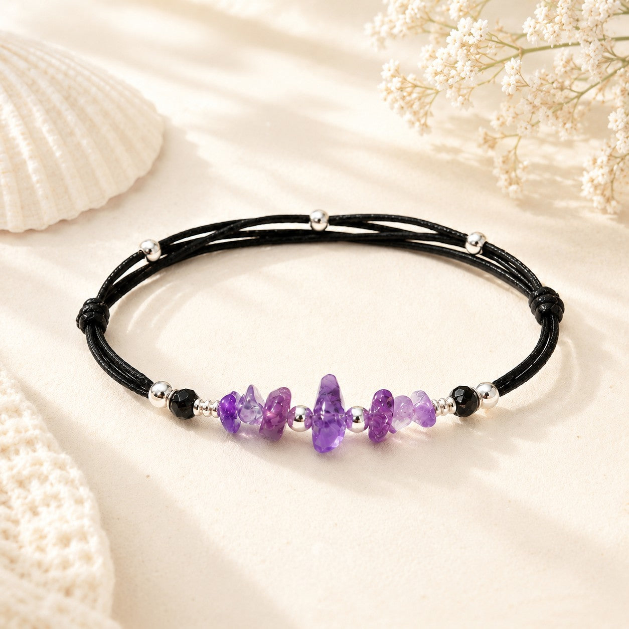 Dainty Amethyst bracelet with smooth purple gemstone nuggets on a black adjustable nylon cord, accented with silver-plated beads and one customizable initial charm. A waterproof, handmade gift for women or teens, perfect for everyday wear and special occasions.
