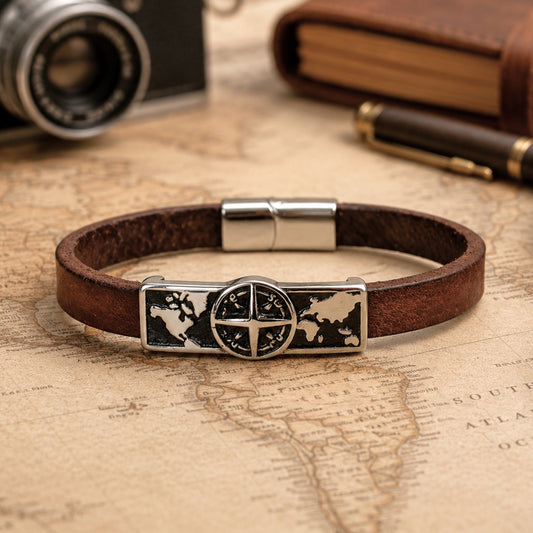 Brown leather travel bracelet with a stainless steel compass and world map centerpiece, featuring a secure magnetic clasp. This minimalist unisex leather bracelet showcases a detailed compass rose over a world map design, symbolizing adventure, exploration, and wanderlust. Handmade with genuine brown leather and polished stainless steel accents, it is a meaningful gift for travelers, hikers, adventurers, pilots, sailors, and anyone who loves to explore the world. 