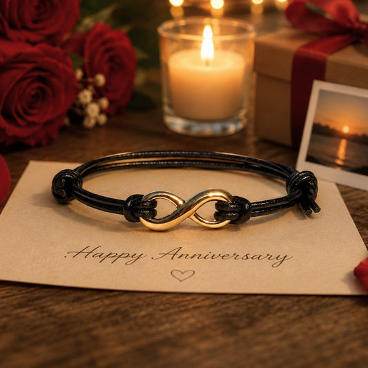 Black leather adjustable infinity bracelet with gold infinity charm on a woman's wrist. Waterproof minimalist bracelet featuring a gold infinity symbol, handcrafted adjustable cord jewelry, meaningful anniversary gift for her, boyfriend, girlfriend, wife, or husband.