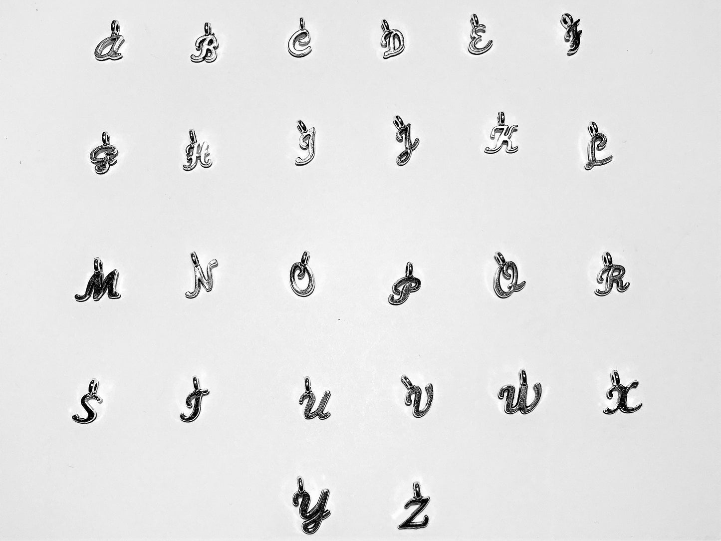 Silver tone Initial letter charms for personalization in alphabetical order.