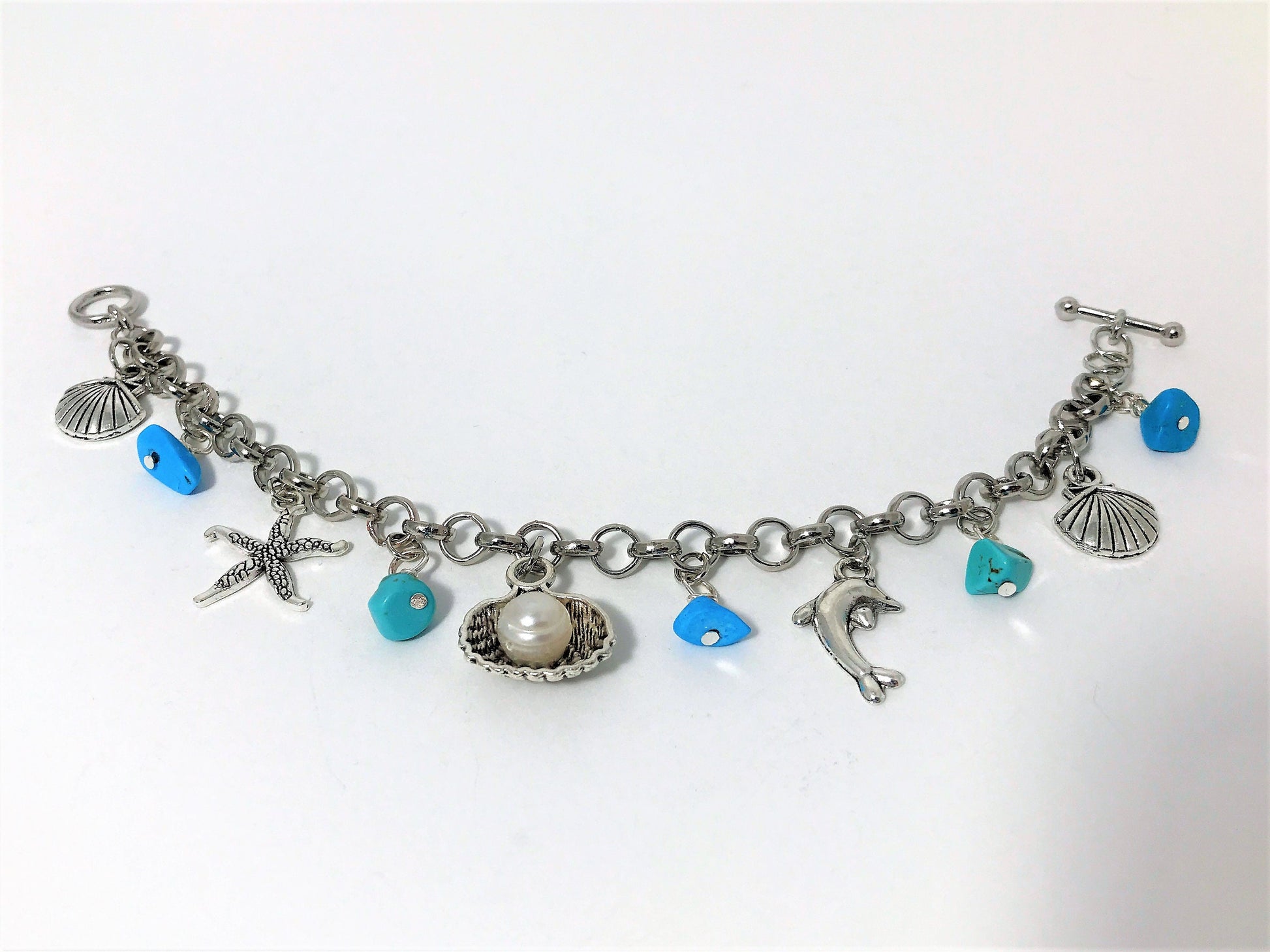 Turquoise Charm Bracelet: Pearl, Shell, Dolphin - Personalized Initial - worn view