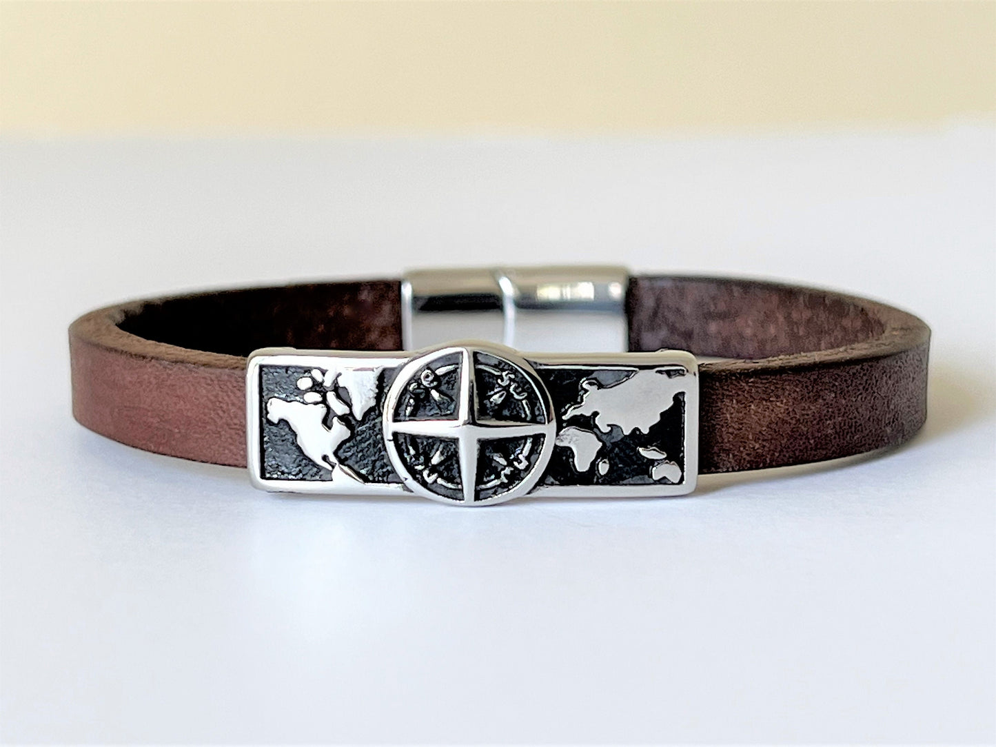 Brown leather bracelet with stainless steel Compass sliding charm and double locking clasp.