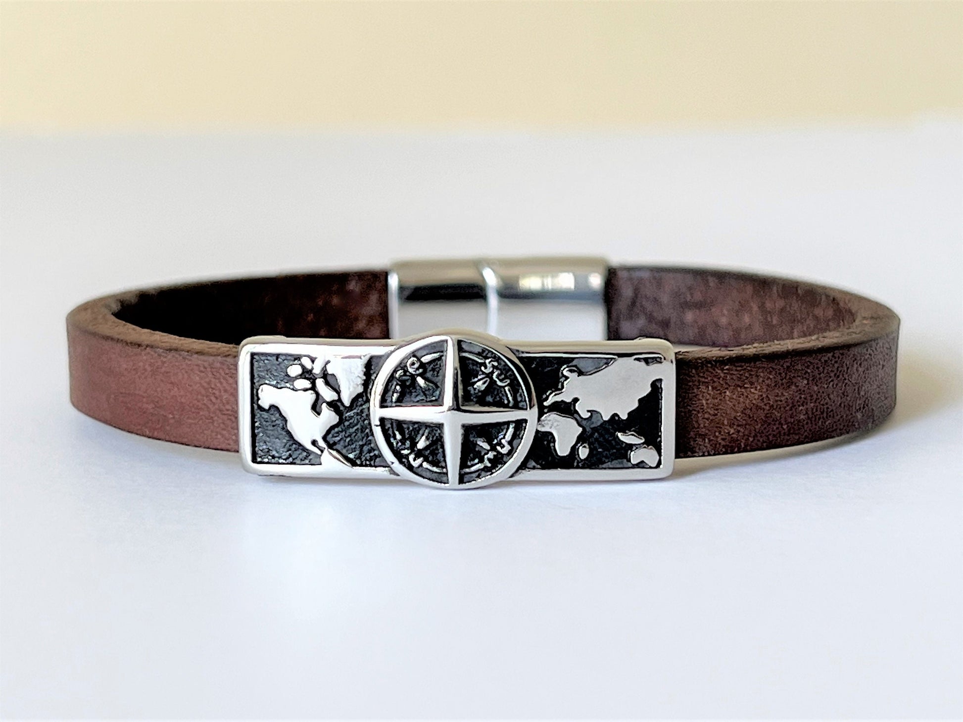 Brown leather bracelet with stainless steel Compass sliding charm and double locking clasp.