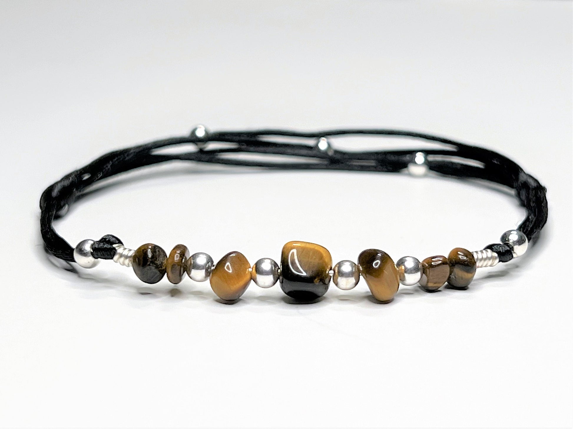 Black silky string anklet with Tiger Eye Gemstone Nuggets. The anklet is adjustable with sliding knots.