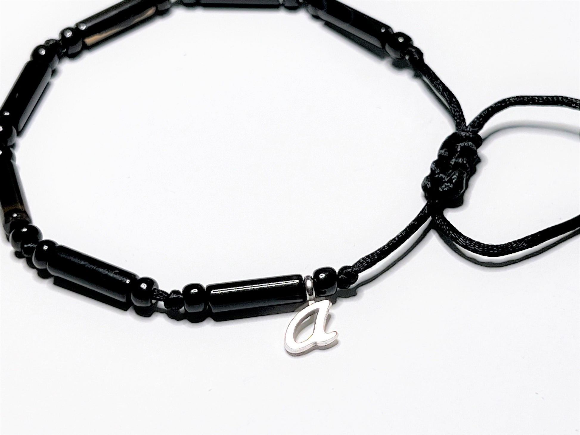 Black Onyx Bracelet can be a Personalized bracelet with one initial letter charm. Showing personalization with the letter"a." Choose from A to Z.