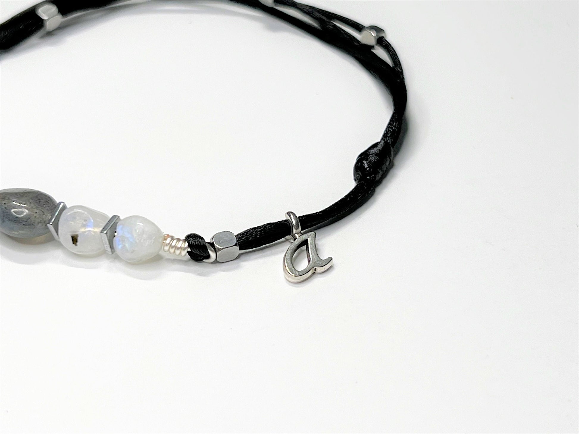 The anklet can be personalized with one initial letter charm.