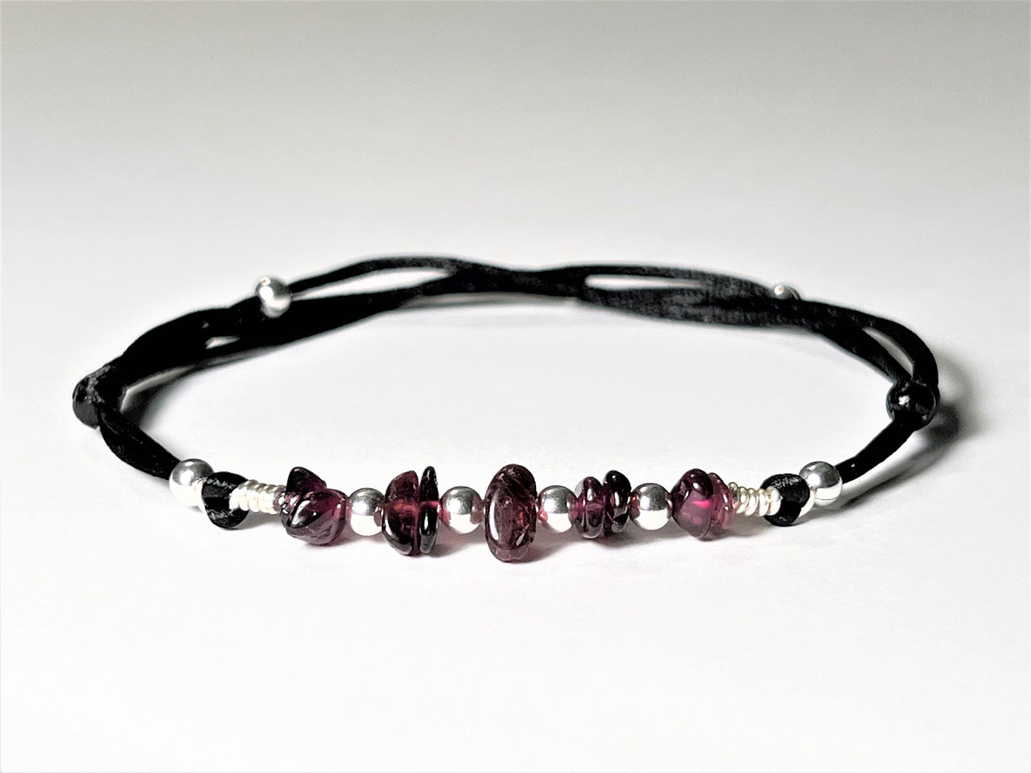 Beautiful but casual Garnet Anklet. Garnet natural gemstone size of uneven smooth chips on a silky nylon string. Garnet crystals embellished with silver-plated tiny round beads. The anklet is adjustable, waterproof, and designed for everyday wear.