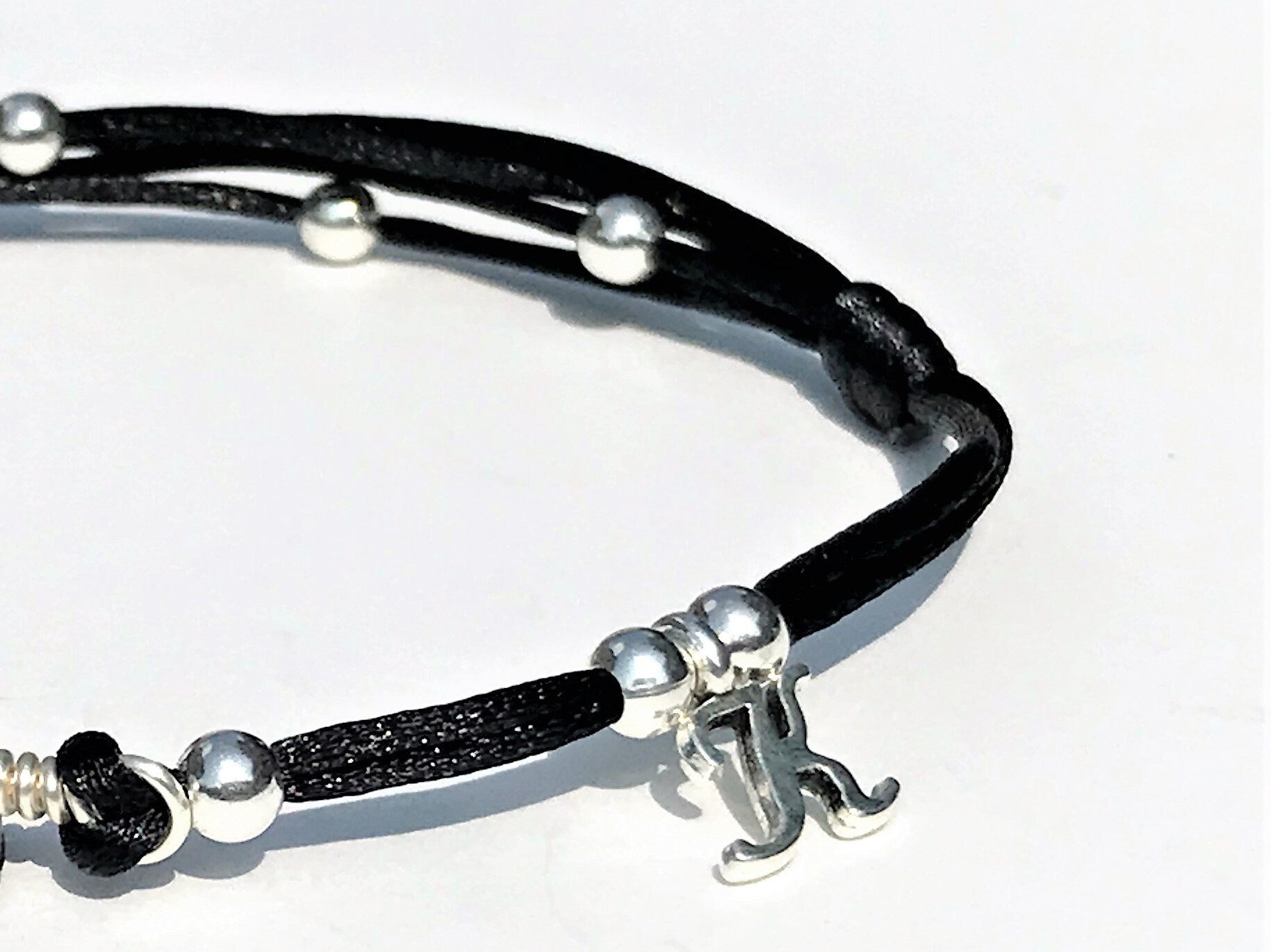 Garnet Anklet with personalization. An initial letter charm was added to the string.