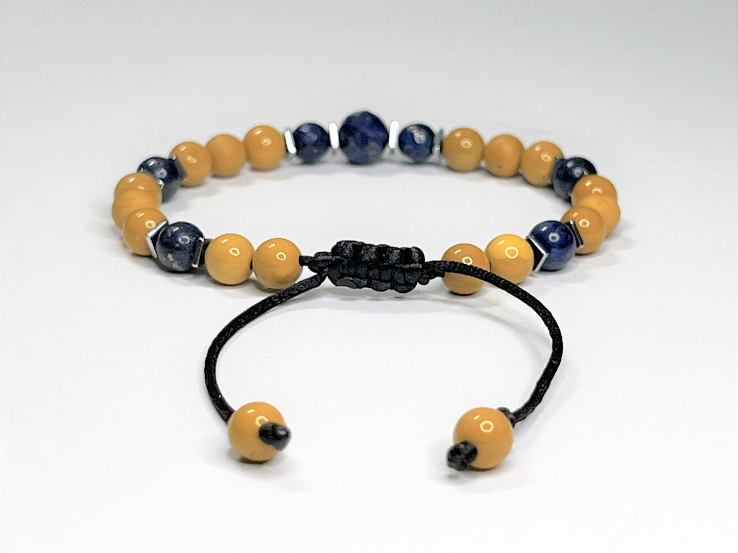 The back side of a bracelet with a macrame adjustable sliding slip clasp.