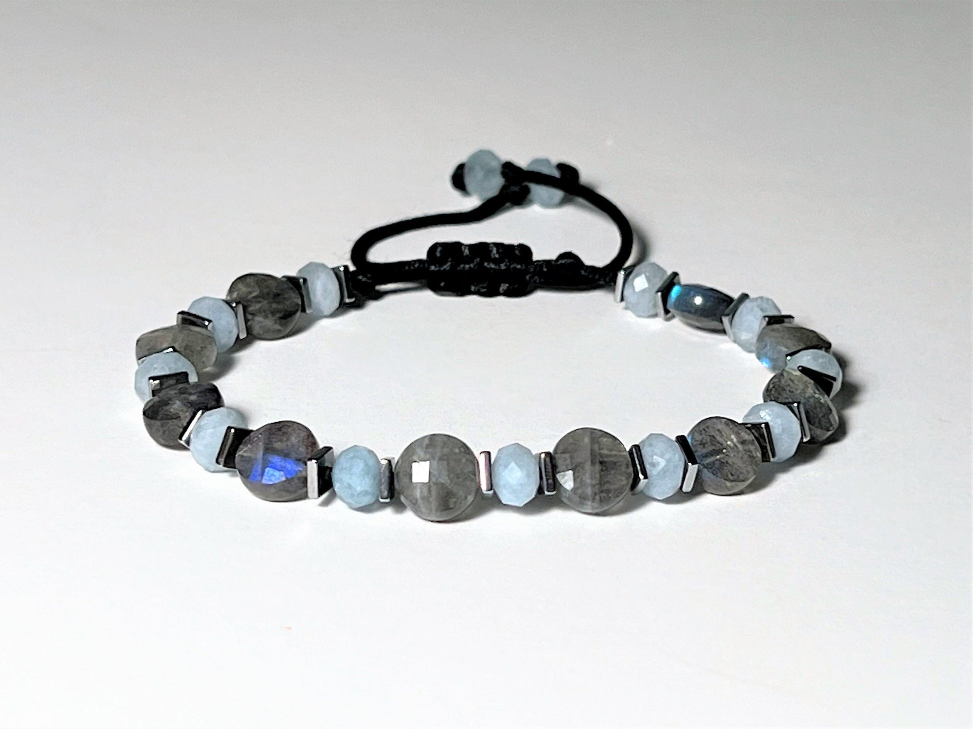Labradorite exhibits fascinating flashes of blue or green color when the gemstone is exposed to bright light and viewed from different angles.