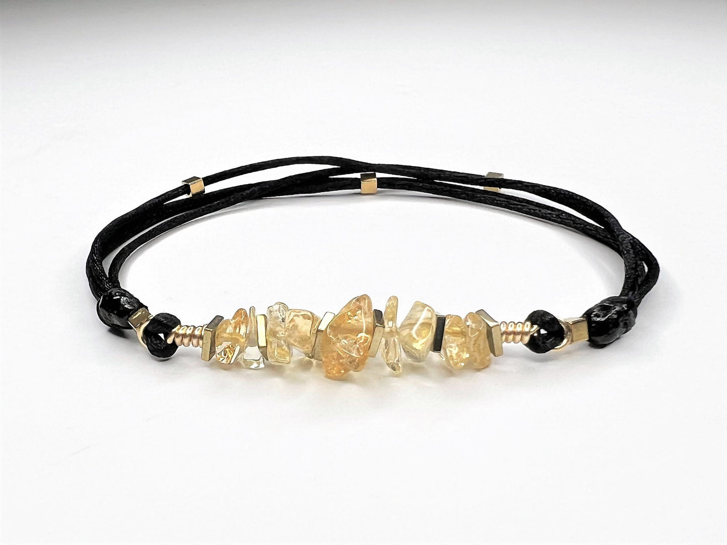 Casual Golden Citrine Bracelet with Natural Citrine Chips on black nylon string. I added tiny gold flat square Hematite beads for extra sparkling. The bracelet is adjustable and waterproof. Easy to put it on and take it off.