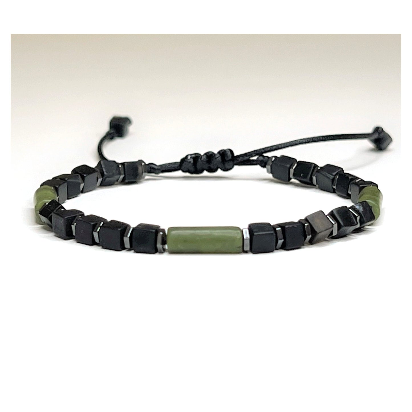 Handcrafted Adjustable 4 mm Black Onyx Cube Bracelet with 3 Green Jade Tubes and hematite Beads. Waterproof design for both men and women. Protective and grounding qualities. Sizes from 6-11 inches. Free Shipping and Gift Wrapping. Handmade in Alabama.