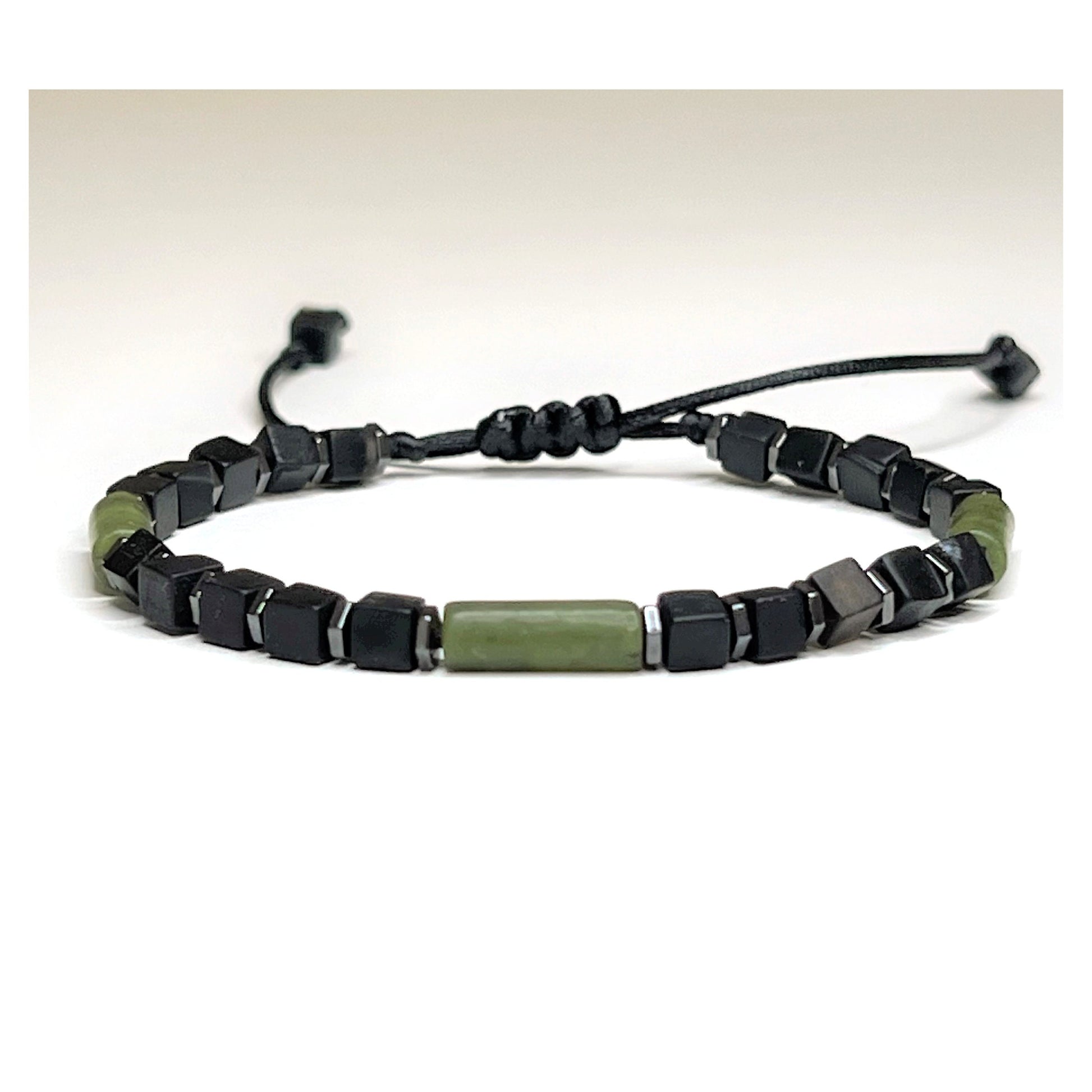 Handcrafted Adjustable 4 mm Black Onyx Cube Bracelet with 3 Green Jade Tubes and hematite Beads. Waterproof design for both men and women. Protective and grounding qualities. Sizes from 6-11 inches. Free Shipping and Gift Wrapping. Handmade in Alabama.