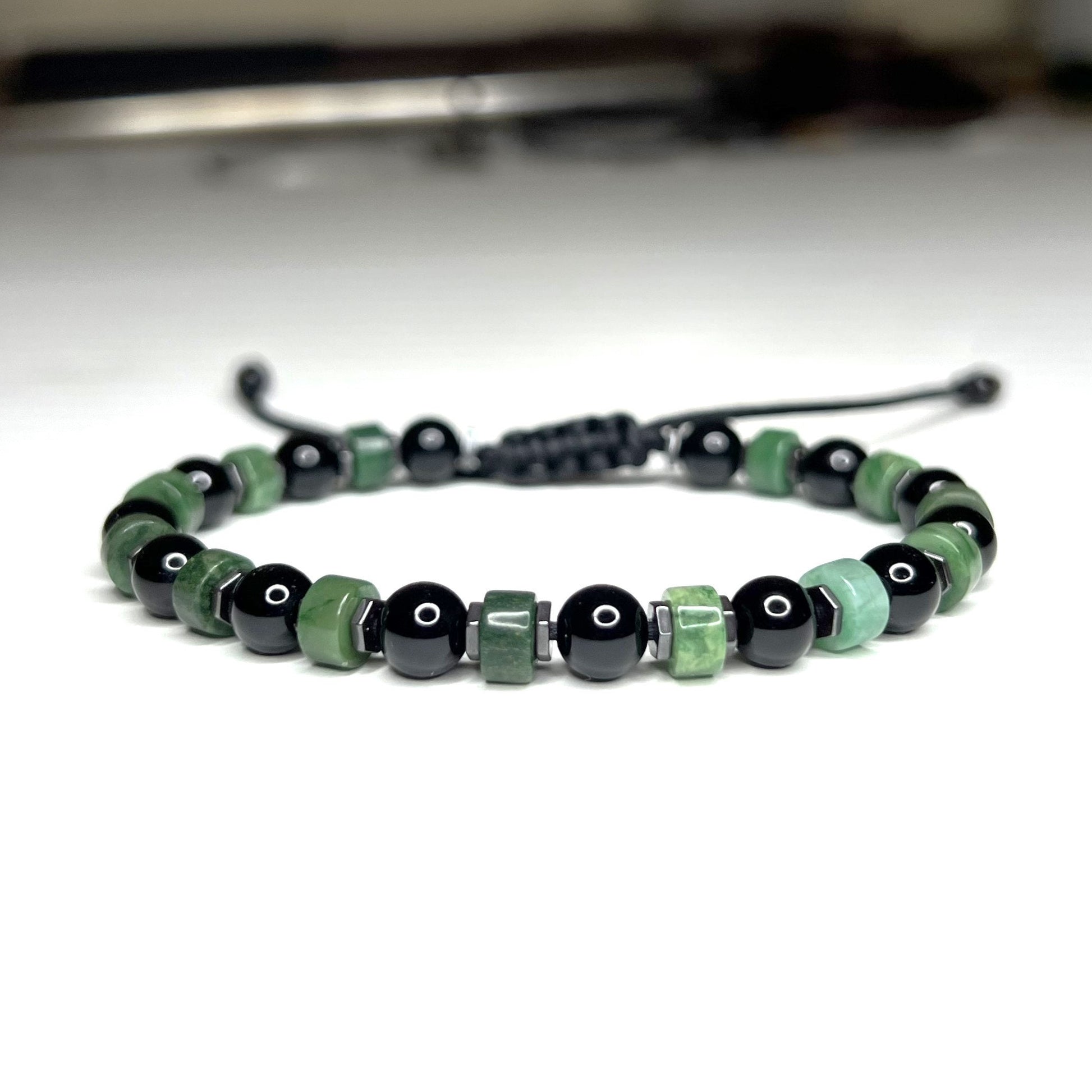 Adjustable  Green Jade and Black Onyx  Bracelet with Hematite Beads. Waterproof design for both men and women. Protective and grounding qualities. Can help fulfill financial goals. Custom sizes from 6 to 11 inches. Free Shipping and Gift Wrapping.