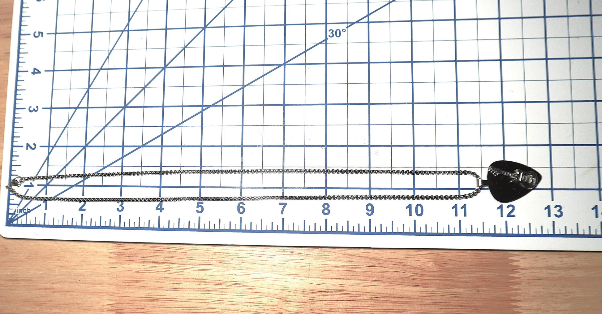 Necklace with a pendant on a ruler for scale measurement