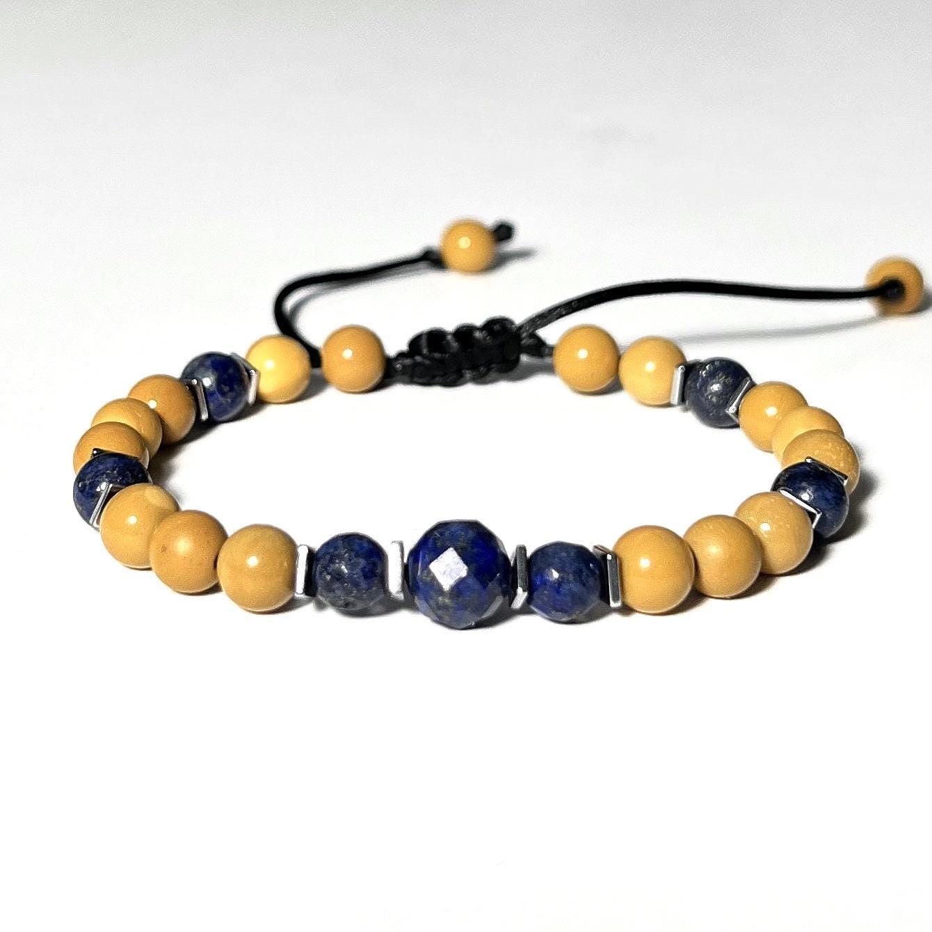 Handcrafted adjustable bracelet featuring an 8mm faceted bright blue Lapis centerpiece, surrounded by 6mm round yellow Mookaite, Lapis Lazuli, and square 5 mm Hematite beads. Perfect with denim. Custom sizing is available.