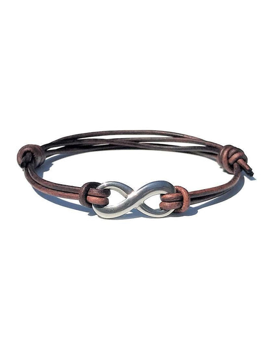 Handmade brown distressed leather bracelet featuring a smooth genuine leather cord and a polished stainless steel infinity charm about 1 inch long. The adjustable sliding knot ensures a perfect fit — an ideal gift for him or her for a wedding or anniversary.