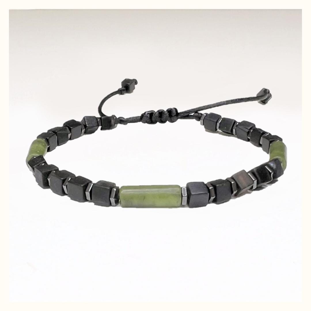 Handcrafted Adjustable 4 mm Black Onyx Cube Bracelet with 3 Green Jade Tubes and hematite Beads. Waterproof design for both men and women. Protective and grounding qualities. Sizes from 6-11 inches. Free Shipping and Gift Wrapping. Handmade in Alabama.