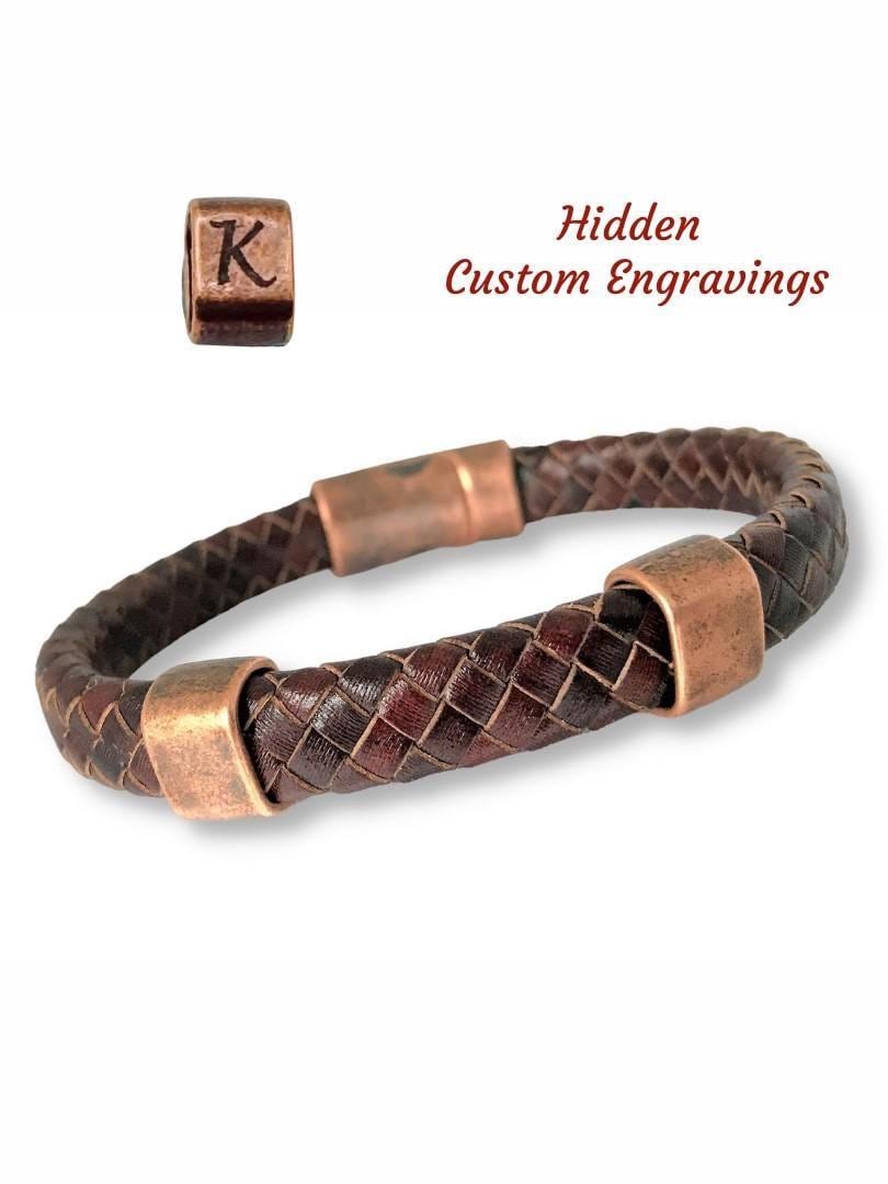 Handcrafted Braided Leather Bracelet with 2 Antique Copper Sliders and Magnetic Clasp. The tightly woven leather band adds durability and texture, making it an ideal accessory for men or women. Ideal for Leather Anniversaries. Personalized Sizes and custom-engraved bracelet combines rustic style with meaningful personalization, perfect for gifts or everyday wear. Handwriting Engraving. Complimentary Gift Box and wrapping Included. Made in Alabama.