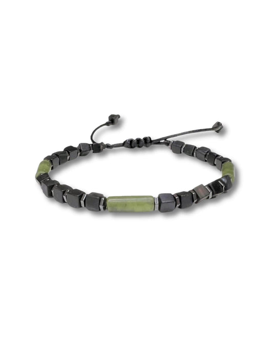 Adjustable handmade bracelet featuring a central cylindrical green jade bead flanked by matte black cubic onyx and faceted hematite spacer beads. Strung on a durable black nylon cord, the bracelet is finished with a macramé sliding knot closure for a custom fit. The contrast between the earthy green jade and dark geometric stones gives the piece a modern, minimalist look. Perfect for daily wear for men and women.