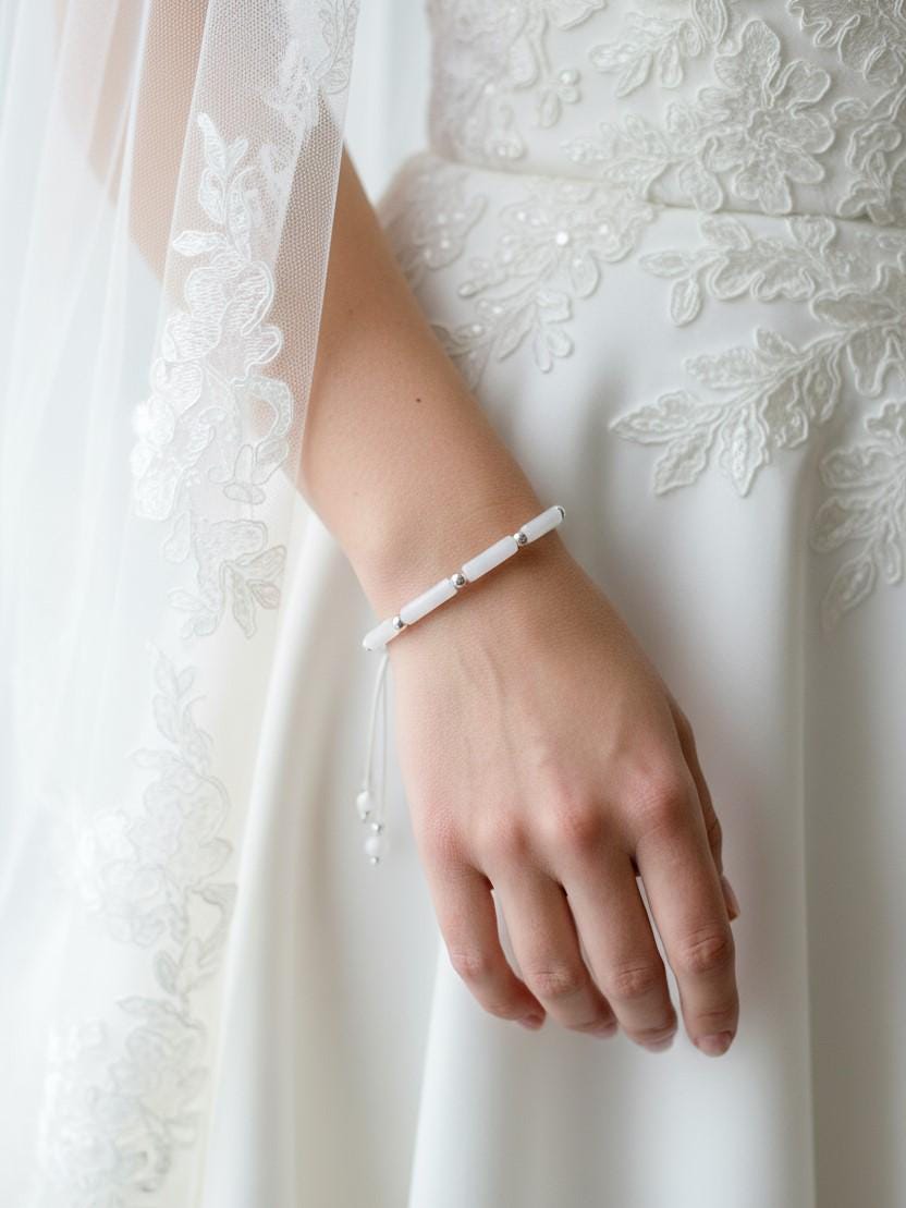 Bribe weating Delicate bracelet with white jade tube beads and silver accents on an adjustable white cord.