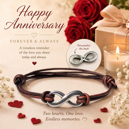 Personalized leather infinity bracelet with a silver stainless steel infinity symbol on a brown leather cord, displayed in a romantic anniversary setting with red roses, a gift box, candlelight, and heart accents. A close-up inset showcases the back of the infinity charm engraved with the names "Olga ♥ Mike," highlighting the hidden custom engraving option. This handmade couples bracelet makes a meaningful anniversary, wedding, Valentine's Day, or personalized gift for a husband, wife, boyfriend, or girlfri