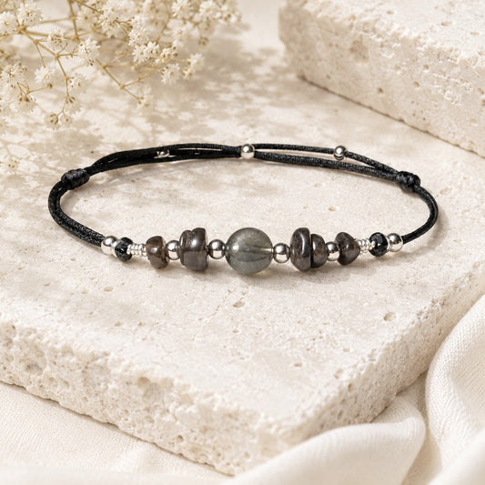 Adjustable black silky nylon cord with Labradorite gemstones on a real silver wire. In the middle of the anklet, one statement gemstone is surrounded by smaller Labradorite gemstones and embellished with tiny stainless steel round beads.