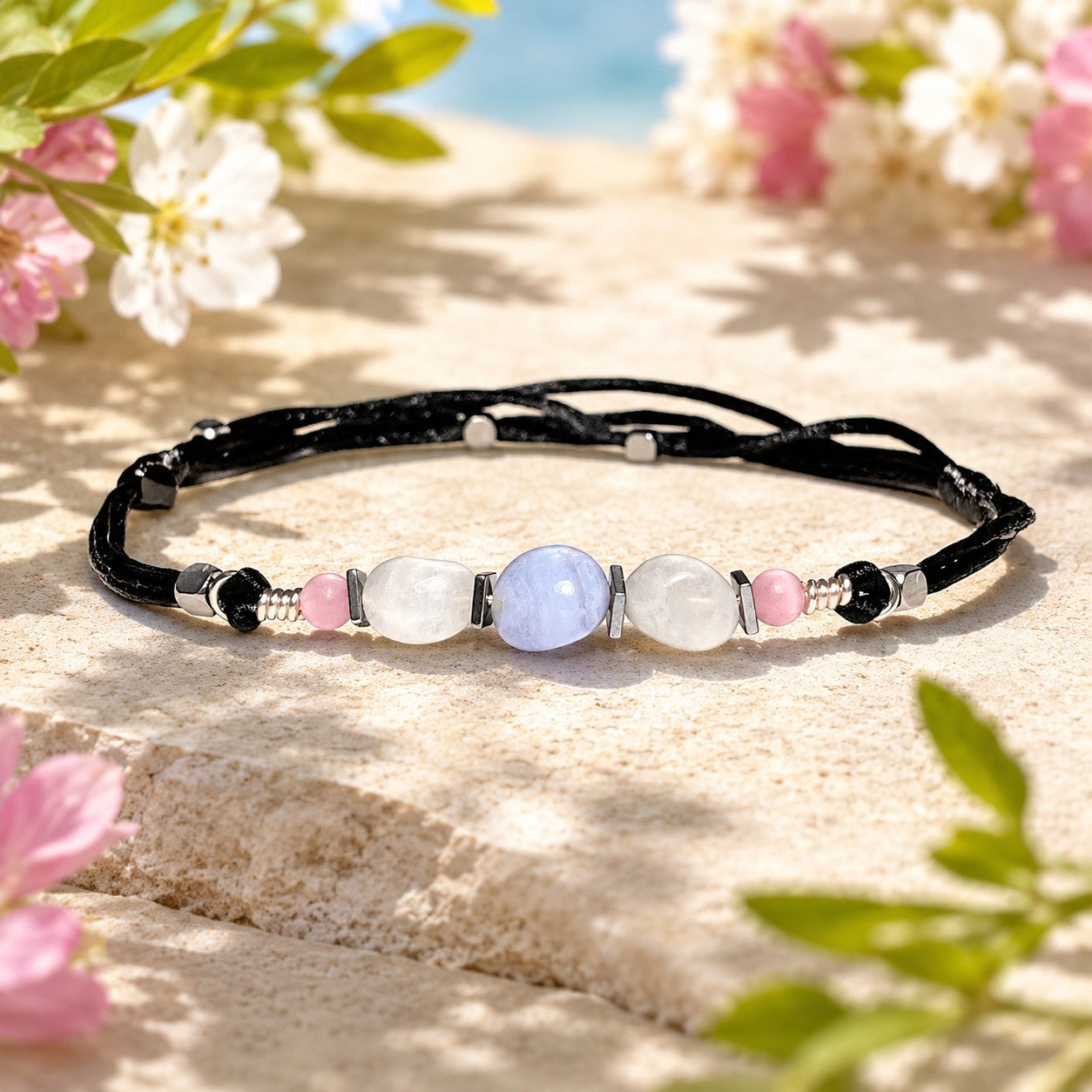 Moonstone and Blue Lace Agate gemstones anklet. The anklet is made with silky black string and adjustable for a perfect size.  
One Blue Lace Agate surrounds smaller moonstone gemstones. In between gemstones are square flat Hematite silver beads.